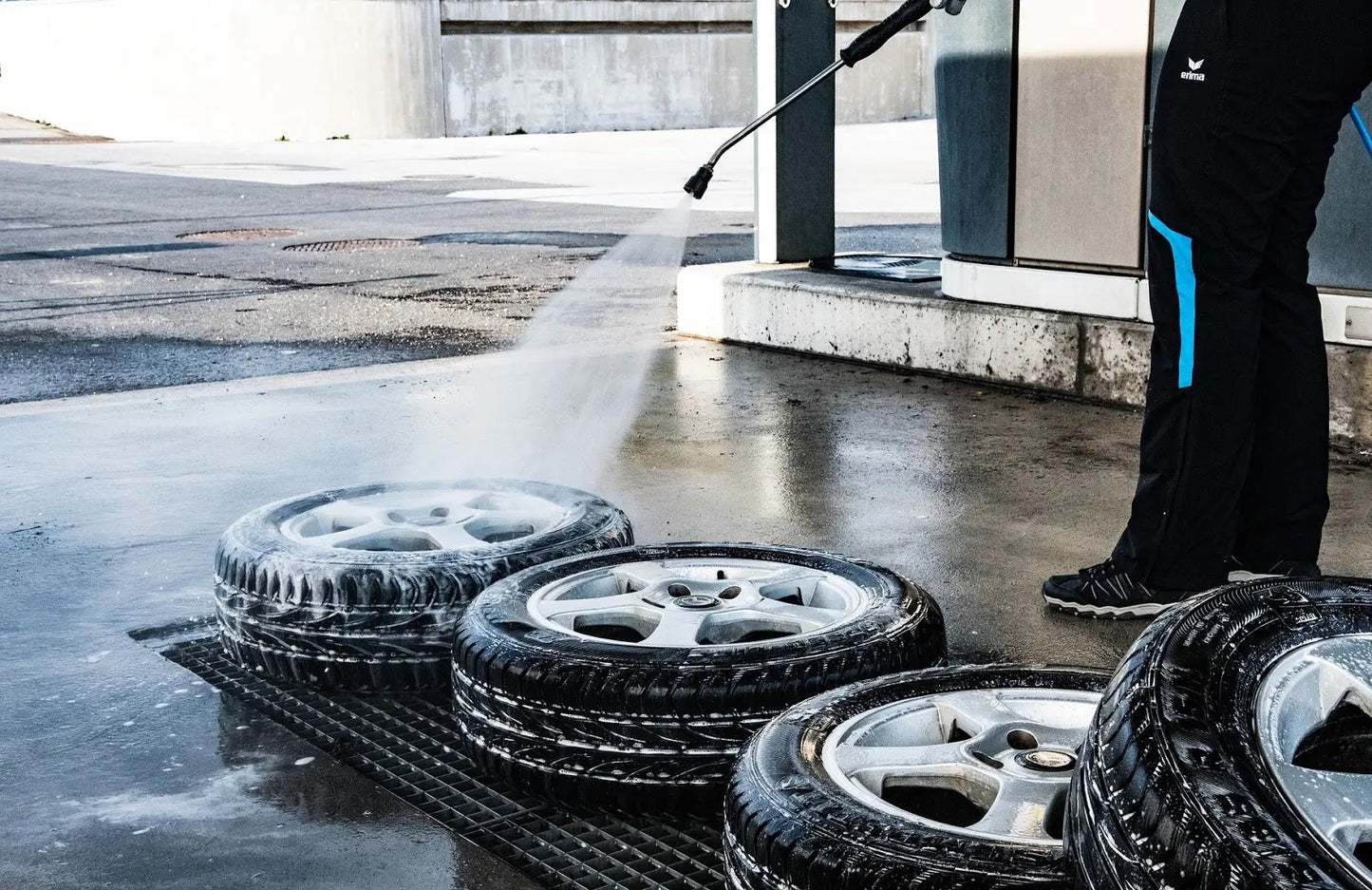 Using a pressure washer to clean tires and rims.