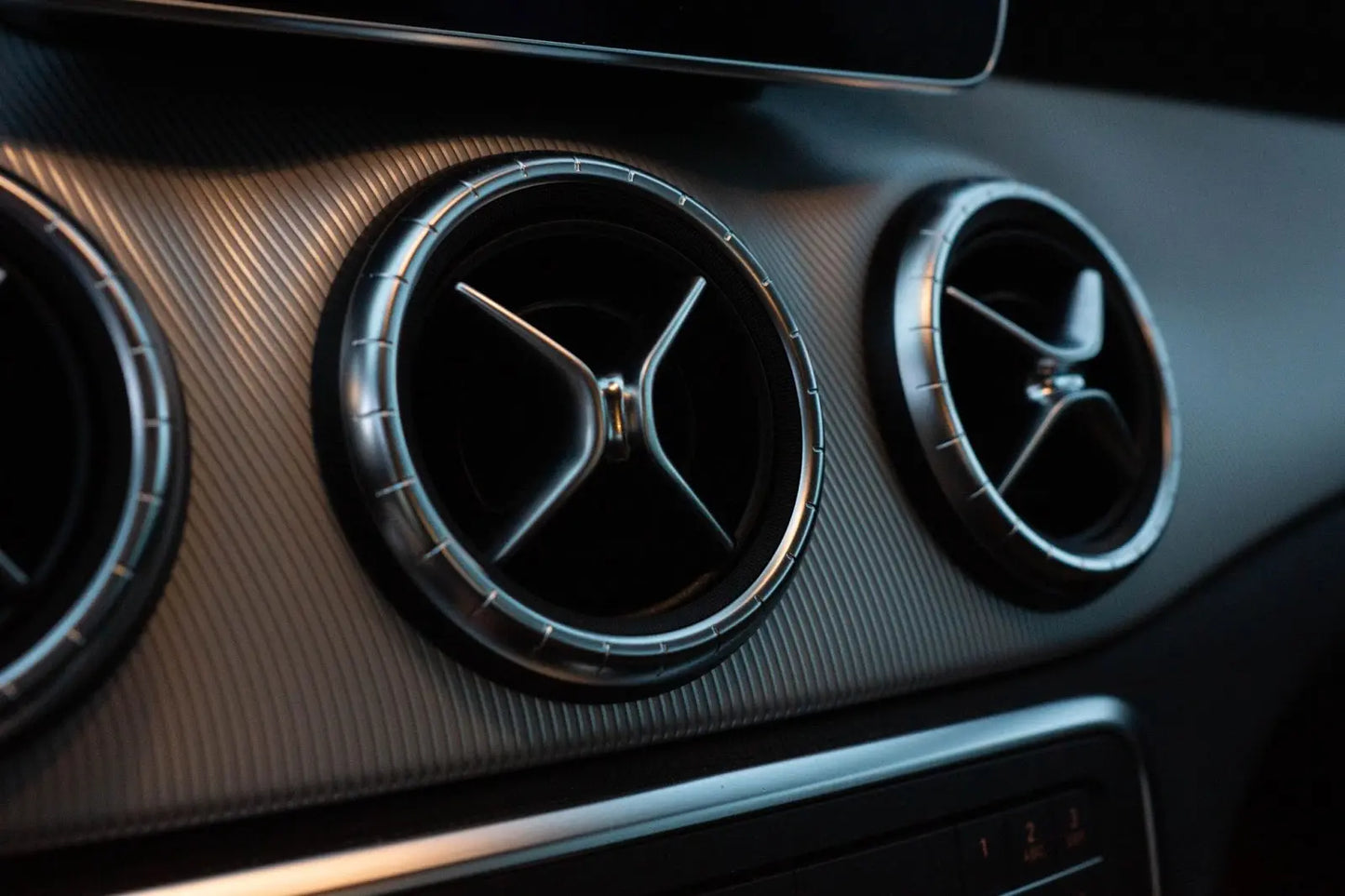 
              Air conditioner vent on the dash of a sports car.